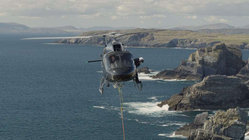 Helicopter performing aerial stunt - Long line. Officially named Human External Cargo.
